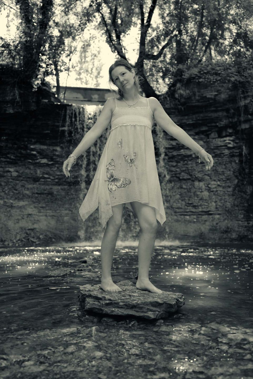 model in front of waterfall - black and white