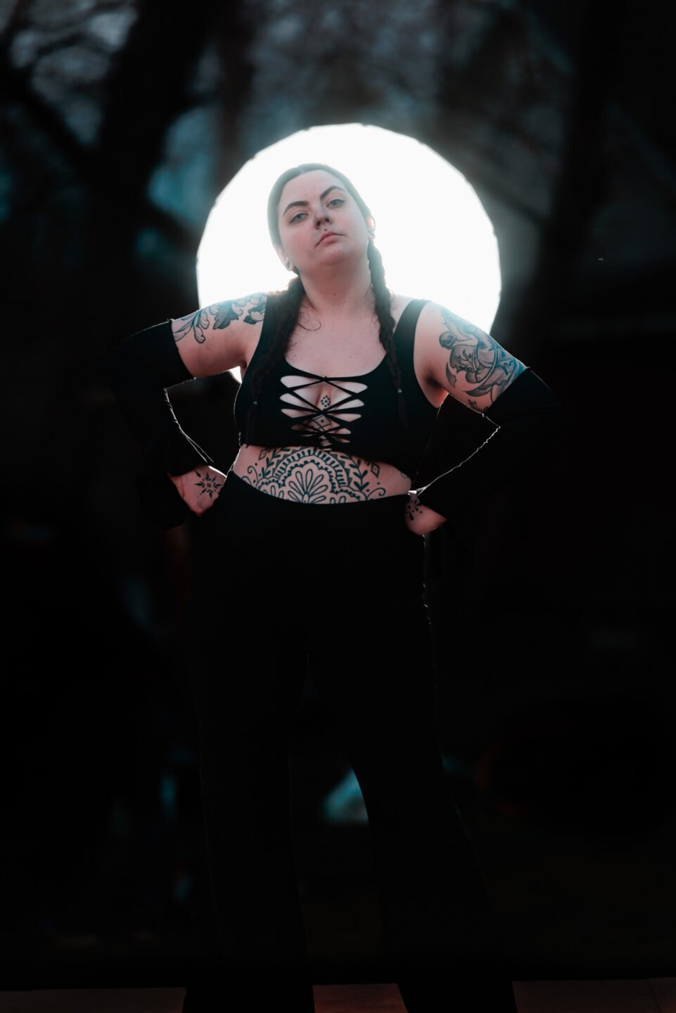 backlit model in black body suit