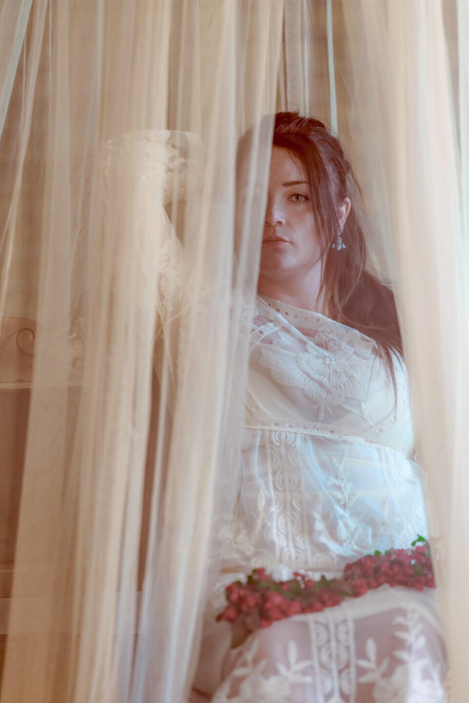 Nataly model in a wedding dress and behind a veil