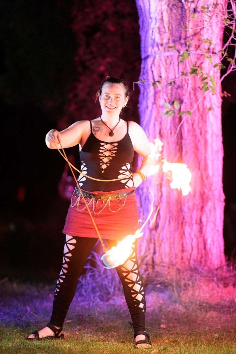 Female fire performer at night