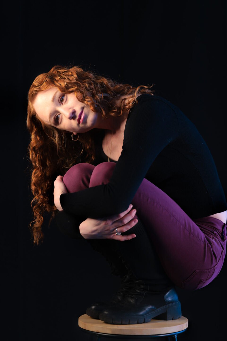 Redhead woman on a tiny chair